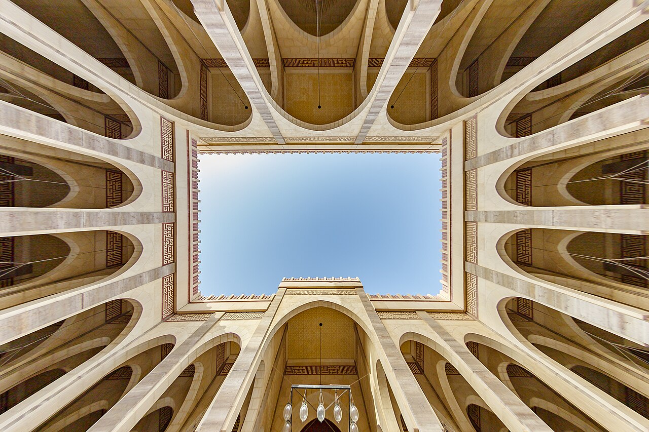 Looking up through the ornate courtyard arches of Al Fateh Grand Mosque in Bahrain